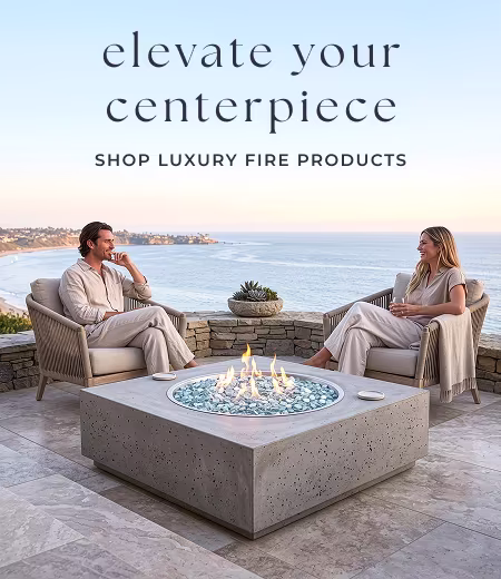 Couple sitting beside modern fire pit. Image Text: elevate your centerpiece SHOP LUXURY FIRE PRODUCTS