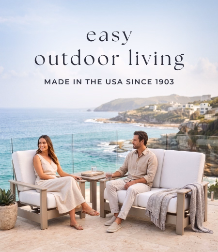 Couple sits on oceanside patio furniture. Image Text: easy outdoor living MADE IN THE USA SINCE 1903