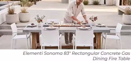 Elementi Sonoma rectangular dining fire table set with place settings and a man arranging the table.