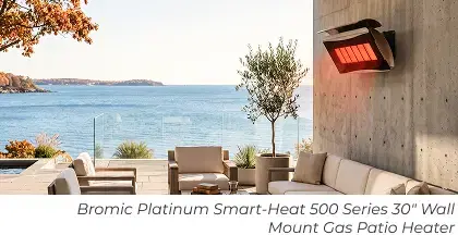 Wall-mounted patio heater above a modern outdoor lounge with cushioned seating and an ocean view.